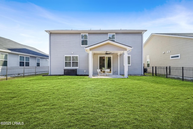 rear view of property with a fenced backyard, ceiling fan, a lawn, and a patio