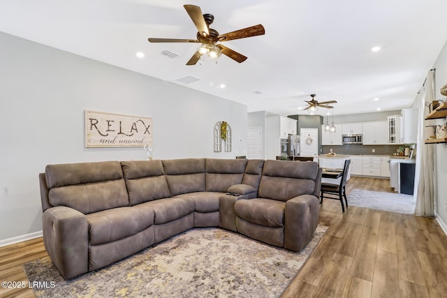 living area with ceiling fan, recessed lighting, visible vents, baseboards, and light wood finished floors