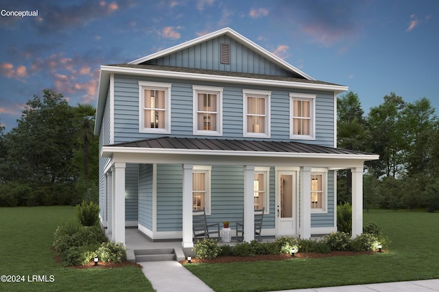 view of front facade featuring a standing seam roof, covered porch, board and batten siding, and a front yard