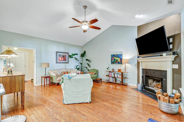 living room featuring lofted ceiling, hardwood / wood-style floors, and ceiling fan