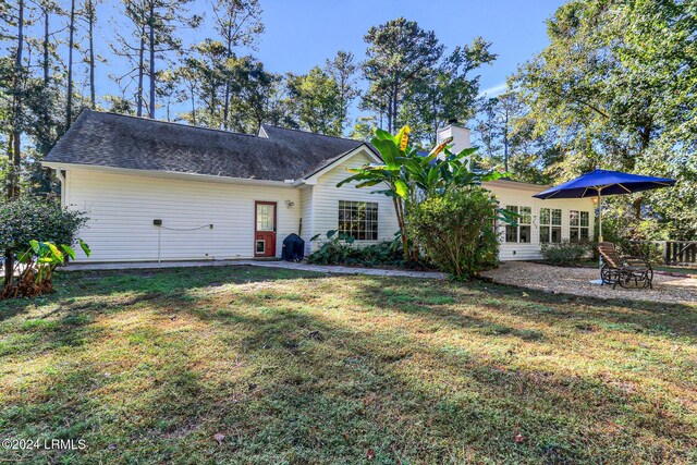 back of house with a yard