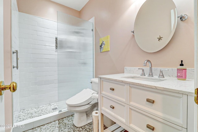 bathroom featuring tile patterned flooring, vanity, a shower, and toilet