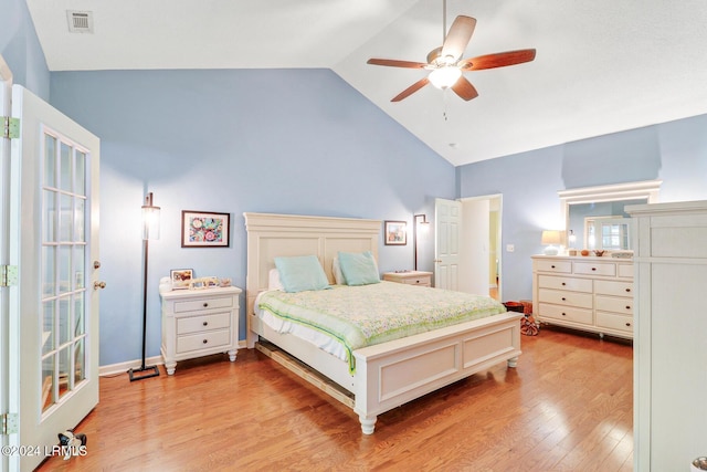 bedroom featuring light hardwood / wood-style flooring, vaulted ceiling, and ceiling fan