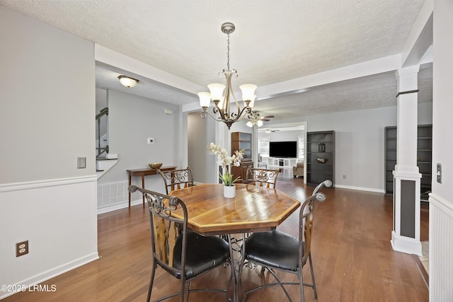18 Lake View Ct, Bluffton, SC 29910 - dining room featuring decorative columns, a textured ceiling, wood finished floors, a chandelier, and a ceiling fan