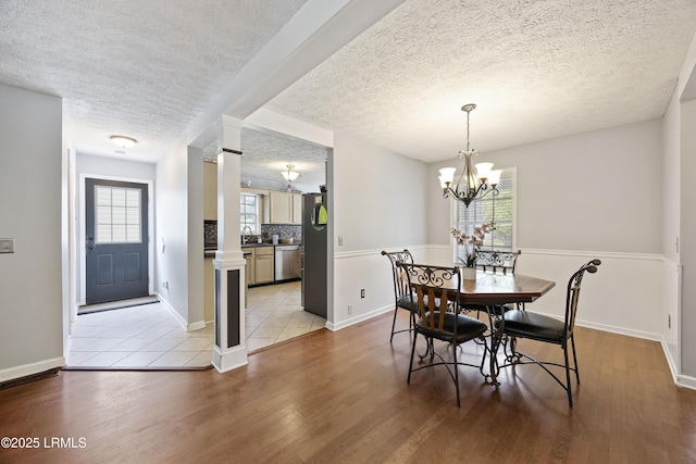 18 Lake View Ct, Bluffton, SC 29910 - dining area with light wood-style floors, a textured ceiling, a chandelier, and baseboards