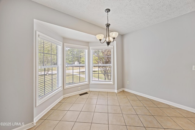 18 Lake View Ct, Bluffton, SC 29910 - unfurnished room featuring light tile patterned floors, a chandelier, a textured ceiling, and baseboards