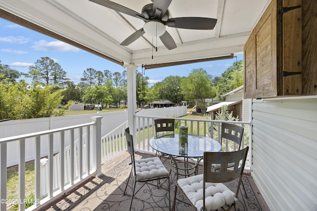 18 Lake View Ct, Bluffton, SC 29910 - wooden deck with a ceiling fan, outdoor dining space, fence, and view of scattered trees