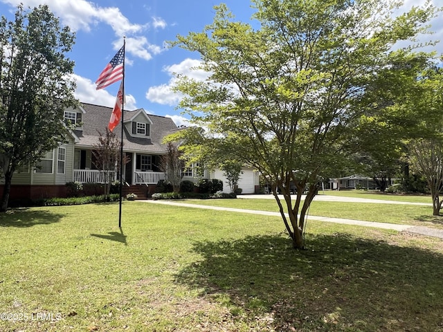 18 Lake View Ct, Bluffton, SC 29910 - view of front facade with an attached garage, covered porch, a front lawn, and a shingled roof