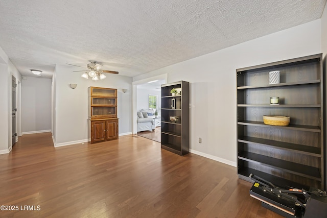 18 Lake View Ct, Bluffton, SC 29910 - unfurnished living room featuring ceiling fan, wood finished floors, a textured ceiling, and baseboards