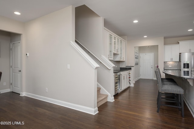 145 Rudder Run, Bluffton, SC 29910 - kitchen with stainless steel refrigerator with ice dispenser, baseboards, beverage cooler, white cabinets, and backsplash