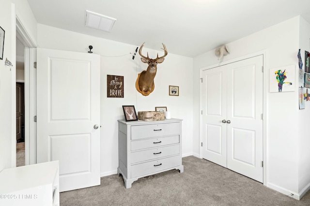 bedroom featuring light carpet, baseboards, visible vents, and a closet