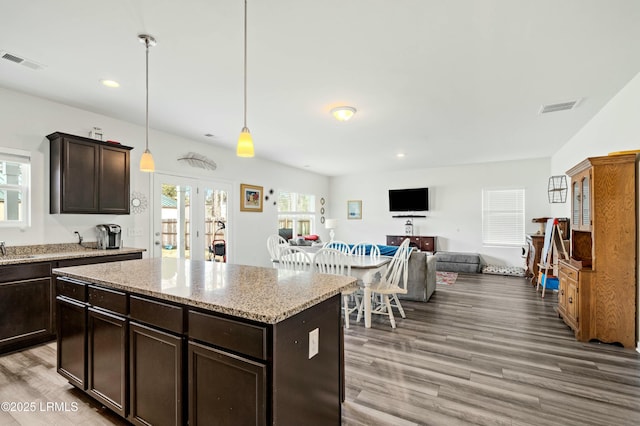 kitchen with light wood-style floors, visible vents, and french doors