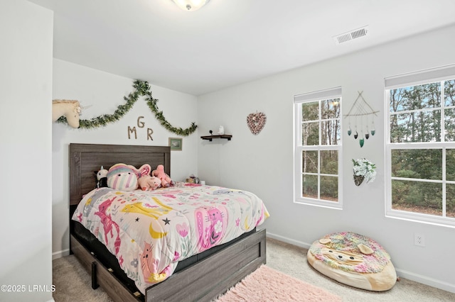 bedroom with carpet floors, visible vents, and baseboards