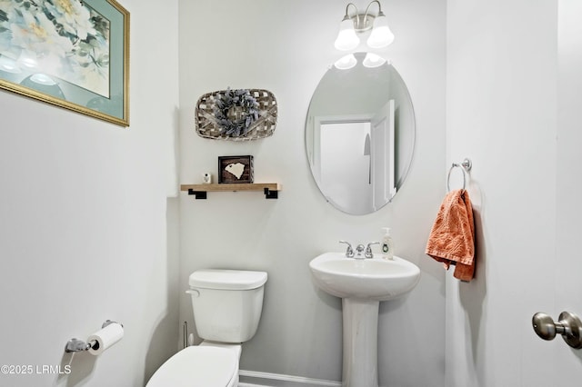 half bathroom featuring a sink and toilet