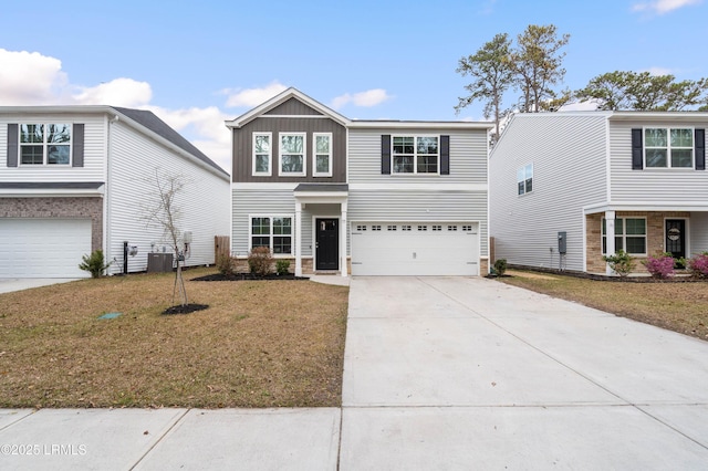 view of front facade featuring a garage, board and batten siding, a front lawn, and concrete driveway