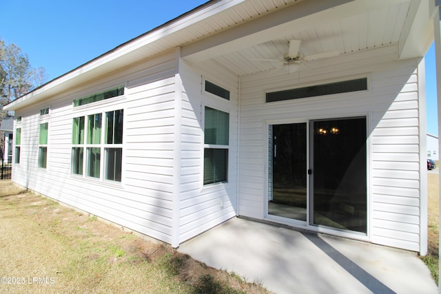 view of side of home featuring ceiling fan and a patio