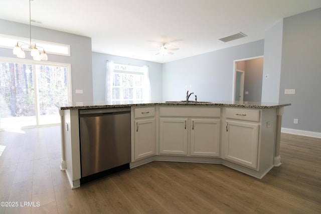 kitchen featuring a sink, visible vents, stainless steel dishwasher, and wood finished floors