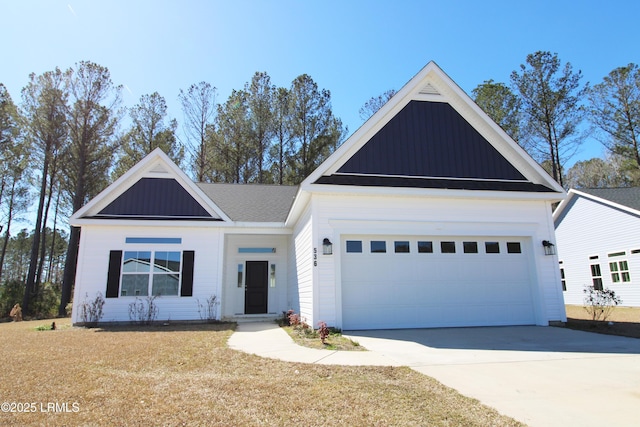 view of front of property with a garage, board and batten siding, and concrete driveway