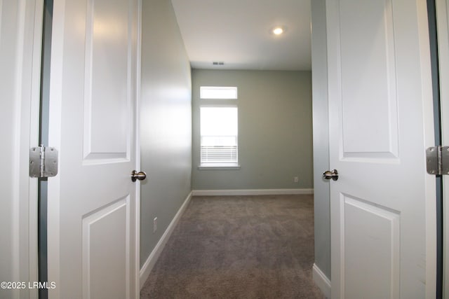 corridor featuring carpet floors and baseboards