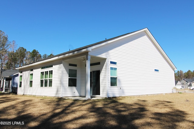 rear view of house with a lawn