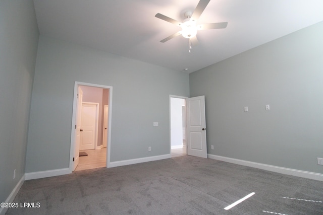 unfurnished bedroom with a ceiling fan, baseboards, carpet flooring, and ensuite bathroom