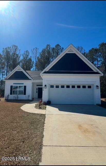 view of front of home with a garage and concrete driveway