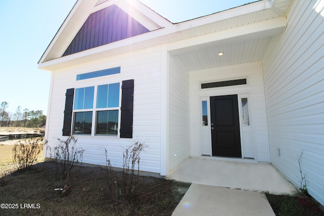 view of exterior entry with board and batten siding