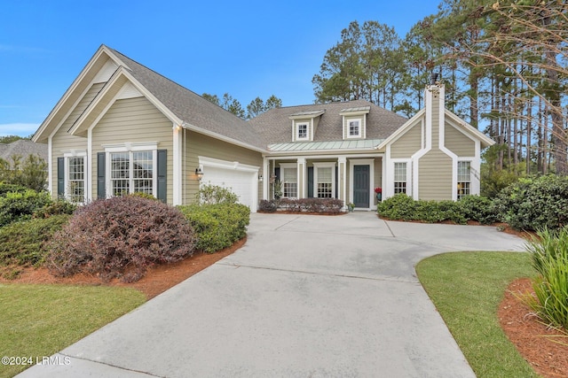 view of front of home featuring a porch, a garage, and a front lawn