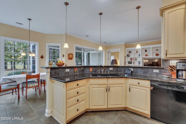 kitchen with sink, dishwasher, dark stone countertops, decorative light fixtures, and tile patterned floors