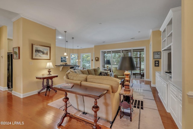 living room featuring light hardwood / wood-style flooring and ornamental molding