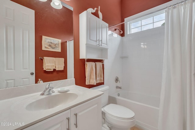 full bathroom with vanity, shower / tub combo with curtain, and toilet