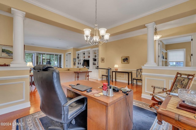 office with crown molding, hardwood / wood-style flooring, a chandelier, and ornate columns