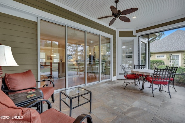 sunroom / solarium featuring ceiling fan