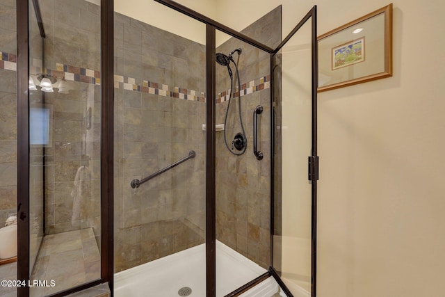 bathroom featuring a shower with door