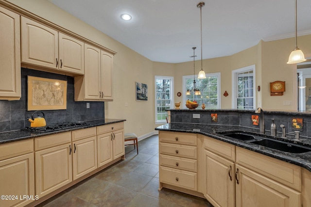 kitchen featuring light brown cabinetry, sink, decorative light fixtures, and black gas cooktop