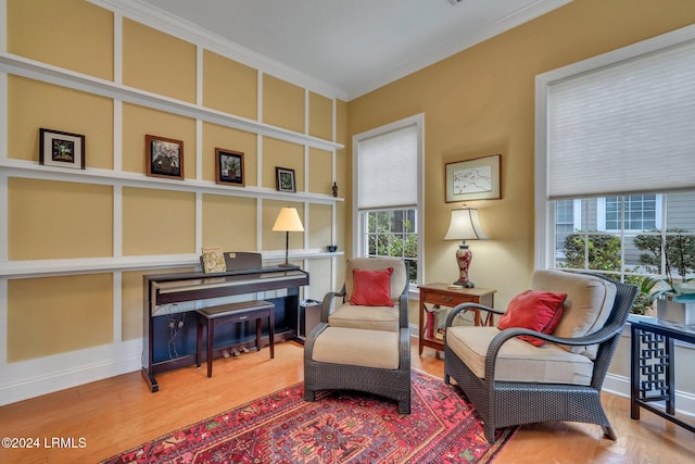 living area featuring crown molding and plenty of natural light