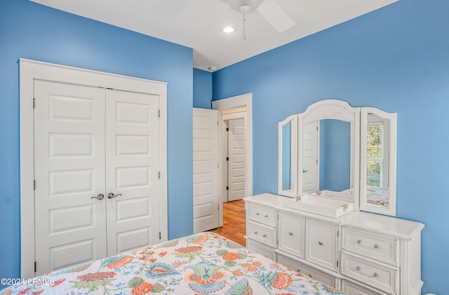 bedroom with light hardwood / wood-style flooring, a closet, and ceiling fan