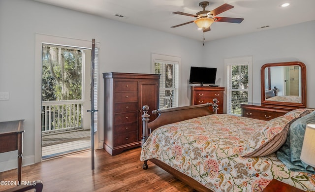 bedroom featuring multiple windows, access to exterior, wood-type flooring, and ceiling fan