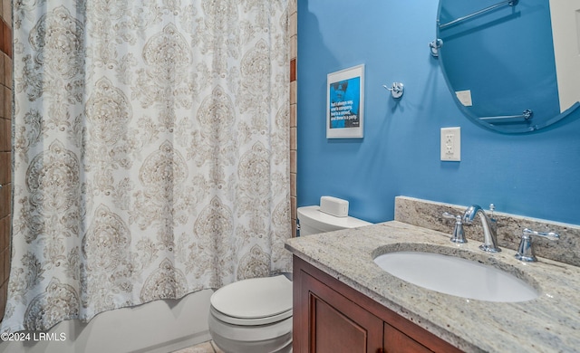 full bathroom with vanity, shower / bath combo, and toilet