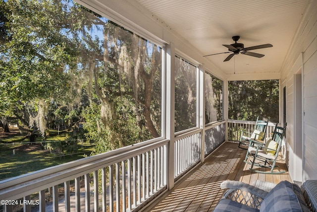 sunroom / solarium featuring ceiling fan