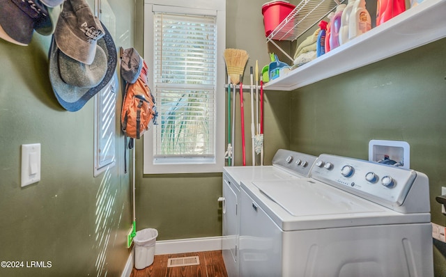 clothes washing area with washer and clothes dryer and hardwood / wood-style floors