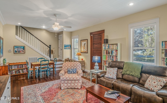 living room featuring ceiling fan and dark hardwood / wood-style flooring