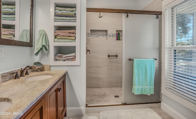 bathroom featuring vanity, tile patterned floors, and a shower with shower door