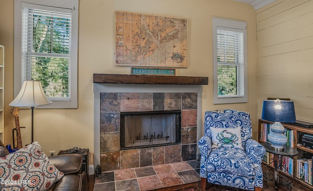 sitting room featuring a fireplace and wood walls