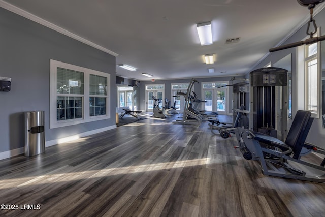 workout area with hardwood / wood-style floors, ornamental molding, and french doors