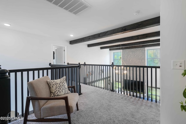 hallway with carpet flooring, a chandelier, and beam ceiling