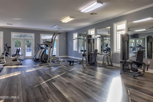 gym featuring crown molding, dark hardwood / wood-style floors, and french doors