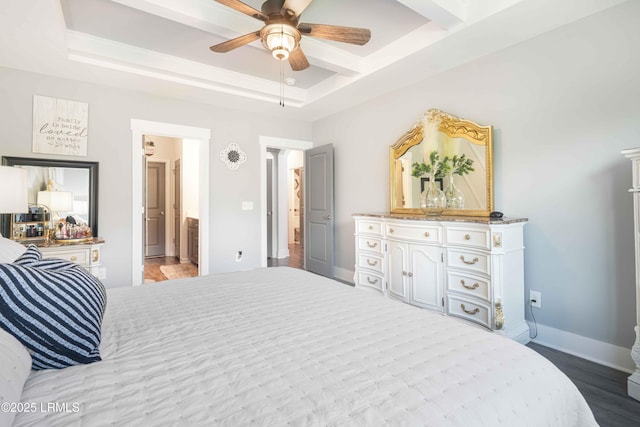 bedroom with ceiling fan, a tray ceiling, and light wood-type flooring