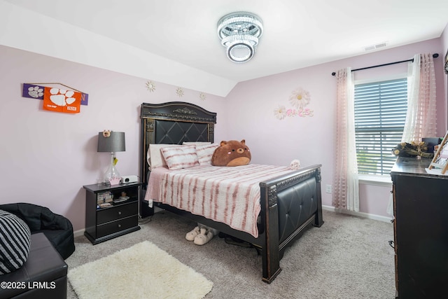 carpeted bedroom with lofted ceiling