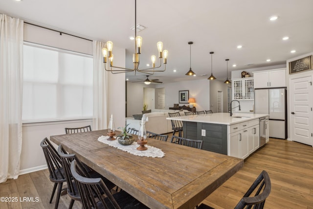 dining space featuring sink and light hardwood / wood-style flooring